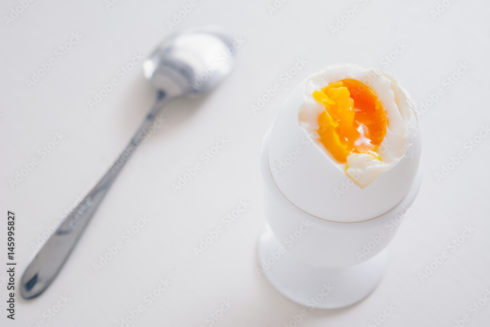 Soft boiled white egg on white background. 