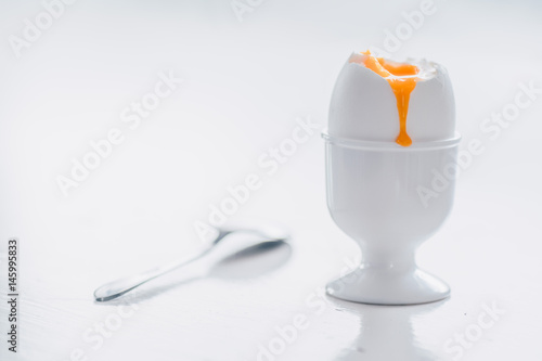 Soft boiled white egg on white background.  photo