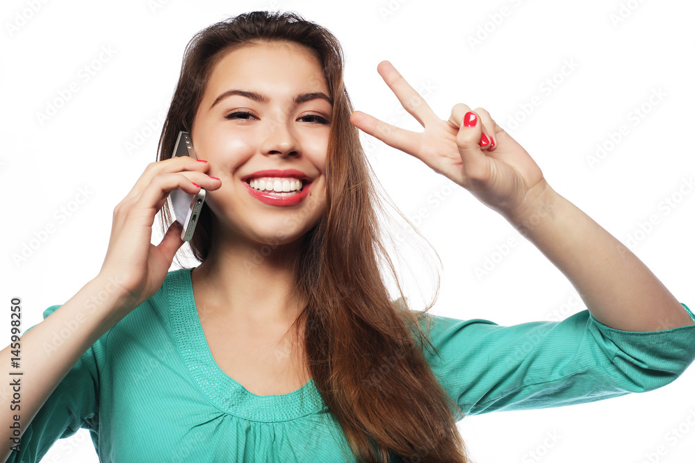 Cheerful woman talking on the phone isolated on a white backgrou Cheerful woman talking on the phone isolated on a white backgrou