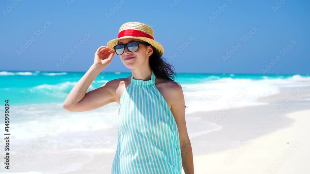 Beautiful woman smiling happy on summer holidays on white beach. Happy girl walking in summer dress. SLOW MOTION Beautiful woman smiling happy on summer holidays on white beach. Happy girl walking in summer dress. SLOW MOTION