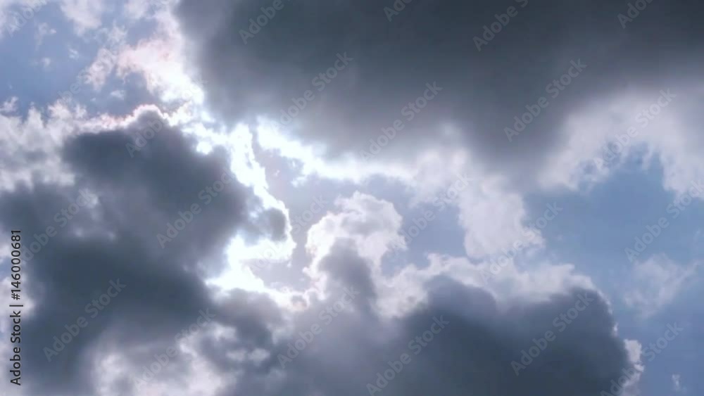 Beautiful cloudscape with large, building clouds and sunrise breaking through cloud mass. Beautiful cloudscape with large, building clouds and sunrise breaking through cloud mass.