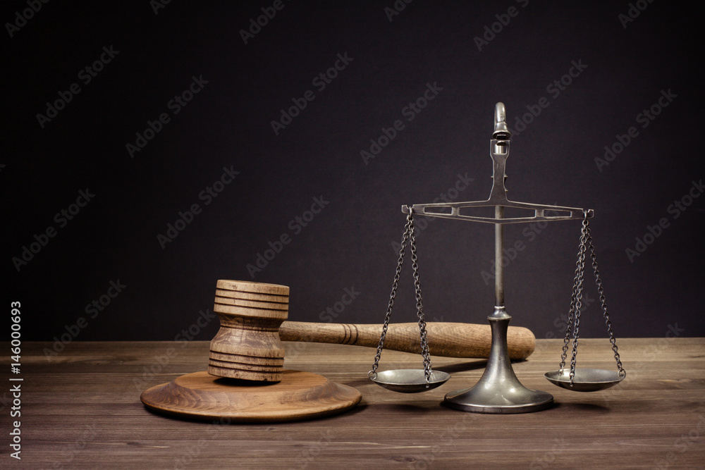 Law scales, wooden judge gavel. Symbol of justice.