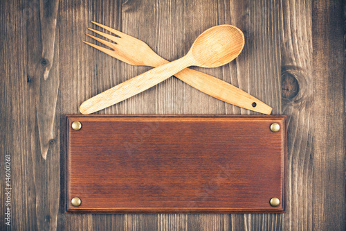 Принти на полотні Sign board, fork and spoon on old wooden background