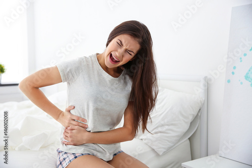 Young woman suffering pain ...