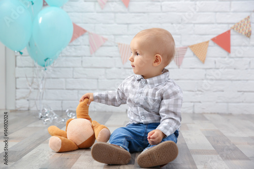 Cute baby boy sitting on fl...