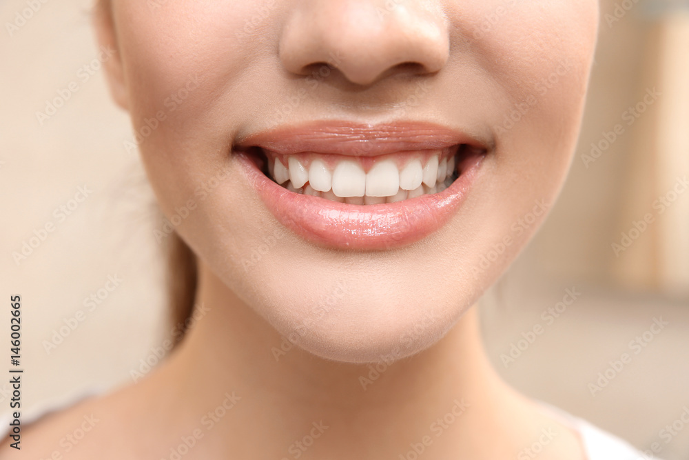 Fototapeta premium Smiling young woman, closeup