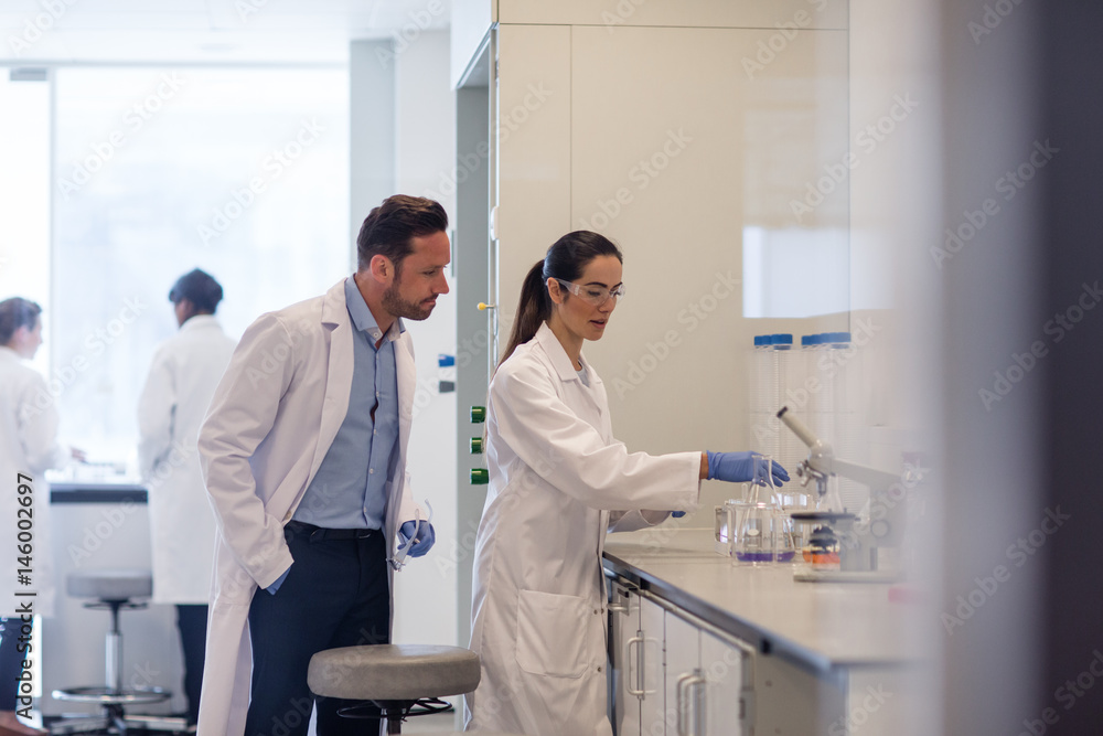 Female student scientist working on an experiment Female student scientist working on an experiment