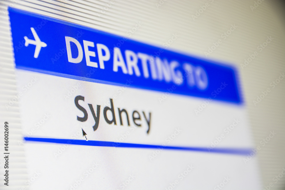 Computer screen close-up of status of flight departing to Sydney, Australia