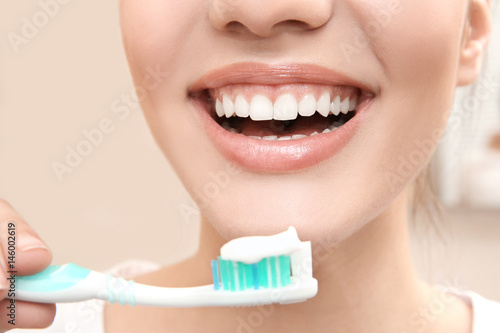 Beautiful woman brushing te...