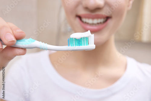 Beautiful woman brushing te...