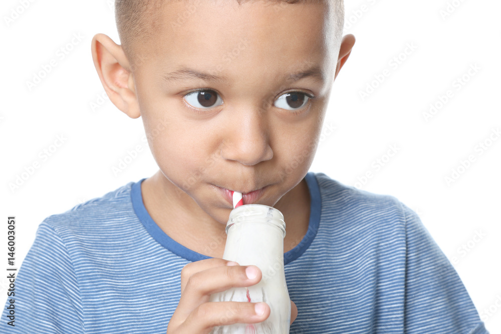 Cute African American boy drinking yogurt on white background, closeup Cute African American boy drinking yogurt on white background, closeup