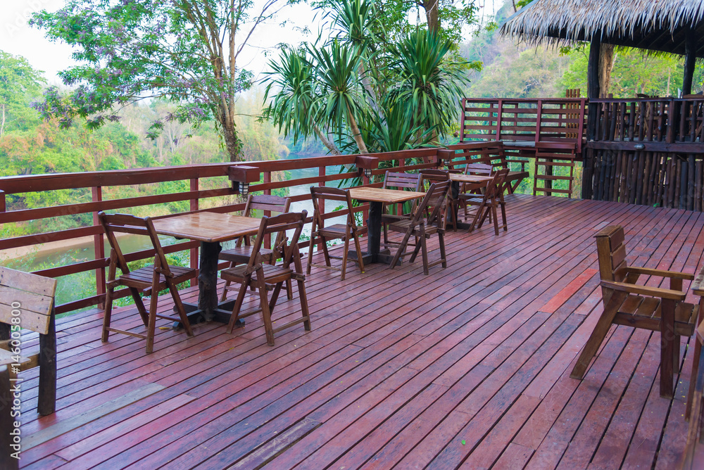 Wooden table and chair in resort and garden, dining set at wooden terrace in restaurant.