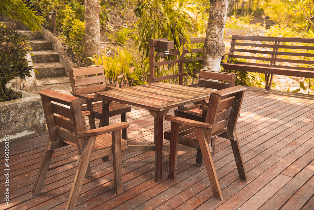 Wooden table and chair in resort and garden, dining set at wooden terrace in restaurant.