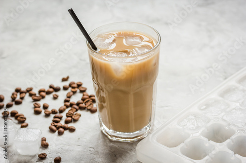 Ice coffee with milk and beans for lunch on stone background