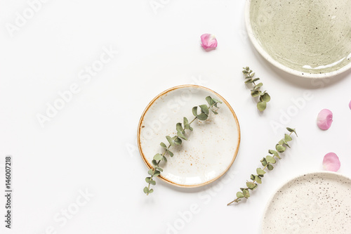 rose, eucalyptus and plates in spring design white background top view mockup