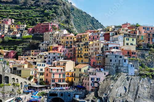 Colorful traditional houses on a rock over Mediterranean sea, Manarola, Cinque Terre, Italy photo