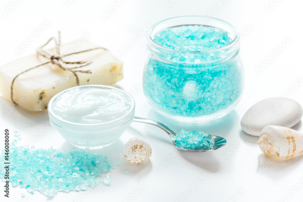 set for bath with salt and shells on white table background