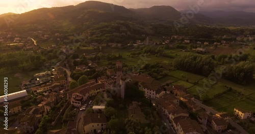 Aerial shot, a small tuscan hamlet Nozzano castello on the hill in the sunset light in Italy, 4K photo