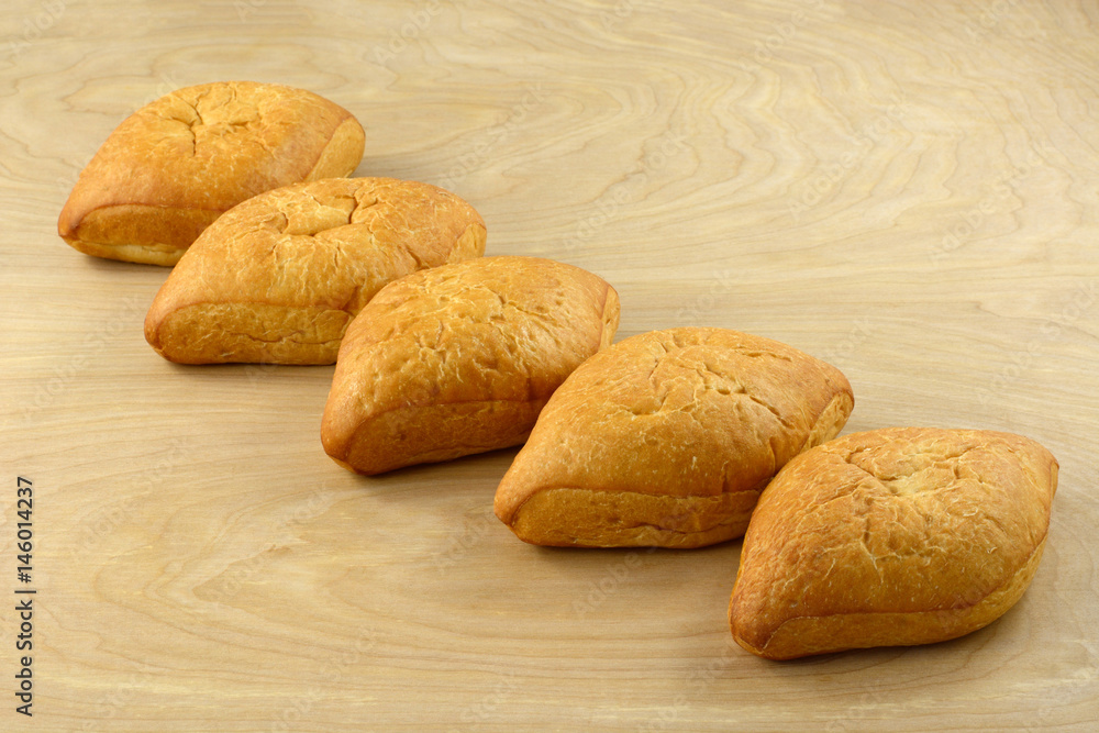 Bolillo Mexican white bread loaves on wooden table Bolillo Mexican white bread loaves on wooden table