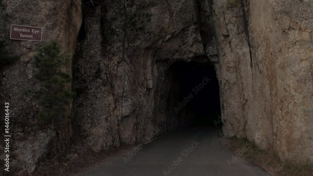 FPV CLOSE UP: Driving through narrow passage in rocky granite wall called Needle's Eye Tunnel and exiting on stone ledge with scenic overlook over the Black Hills National Forest reserve, South Dakota FPV CLOSE UP: Driving through narrow passage in rocky granite wall called Needle's Eye Tunnel and exiting on stone ledge with scenic overlook over the Black Hills National Forest reserve, South Dakota