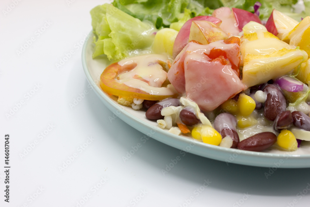 Closeup mixed of fresh salad and fruit on dish. Corn, red beans, pineapple and papaya on white background. Closeup mixed of fresh salad and fruit on dish. Corn, red beans, pineapple and papaya on white background.