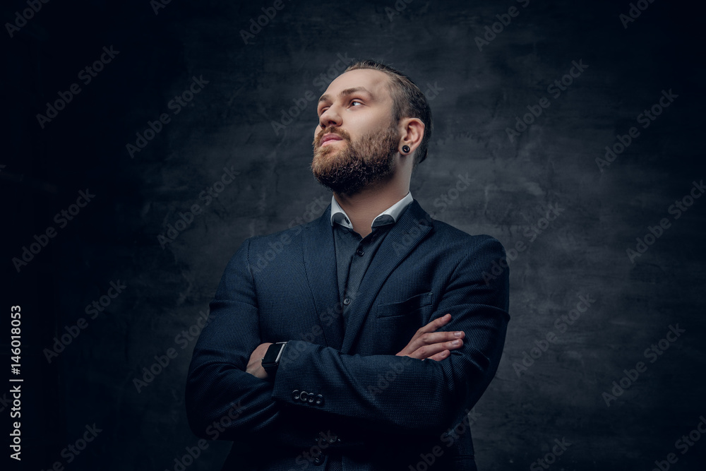 A stylish bearded male dressed in a suit and sunglasses over dark grey background. A stylish bearded male dressed in a suit and sunglasses over dark grey background.