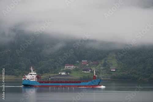 Ship Boat on the fjords of Norway, mountain in the background © Raimond Klavins