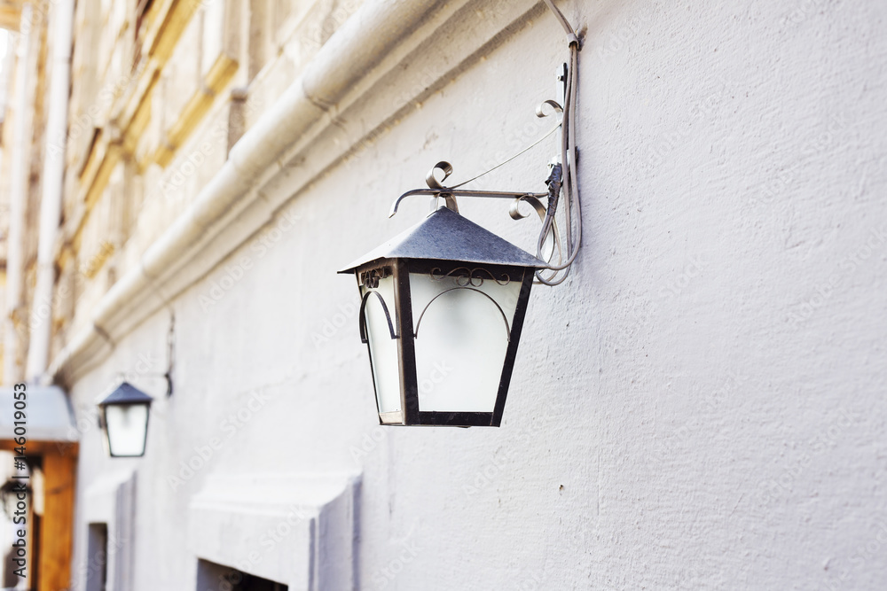 Lantern on the wall. The facade of the building Lantern on the wall. The facade of the building
