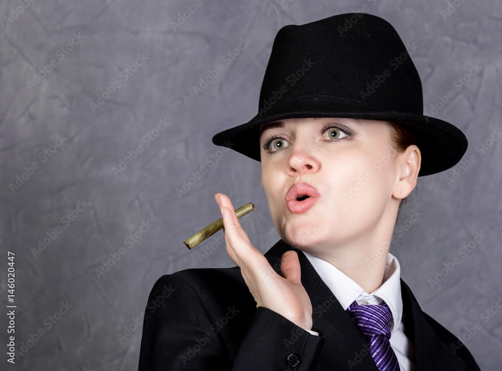Young woman in manly style with mini cigar on gray background, girl in  man's suit and tie, white shirt and hat Stock Photo | Adobe Stock