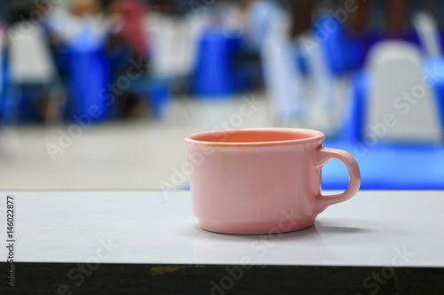 coffee cup pink in seminar conference room background. select focus with shallow depth of field