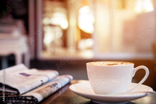 Cappuccino coffee cup on the table, warm tone  photo