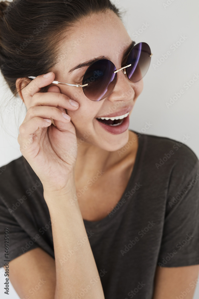 Beautiful woman in brunette laughing in sunglasses Beautiful woman in brunette laughing in sunglasses