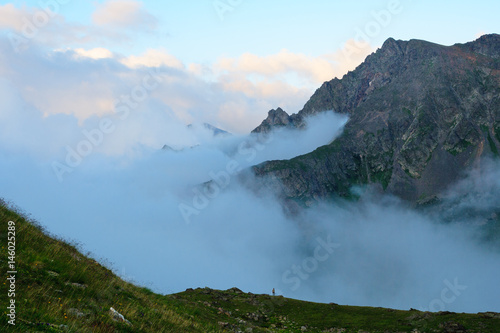 Evening fog up the gorge between mountains. Western Caucasus.