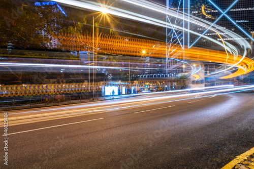 light trails on city street with cityscape at night in China. © fanjianhua