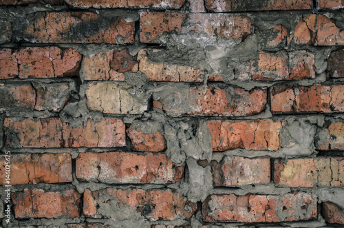 Aged brick wall background texture.Broken bricks dark background.