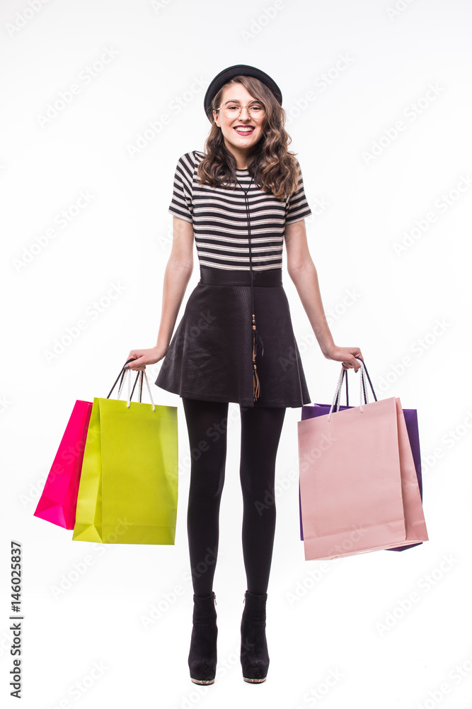 Full length shot of an attractive young woman holding color paper shopping bags isolated on white Full length shot of an attractive young woman holding color paper shopping bags isolated on white