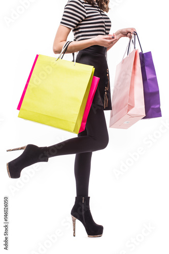 Shopping woman holding shopping bags. Closeup of beautiful women colorful shopping bags. Isolated on white.