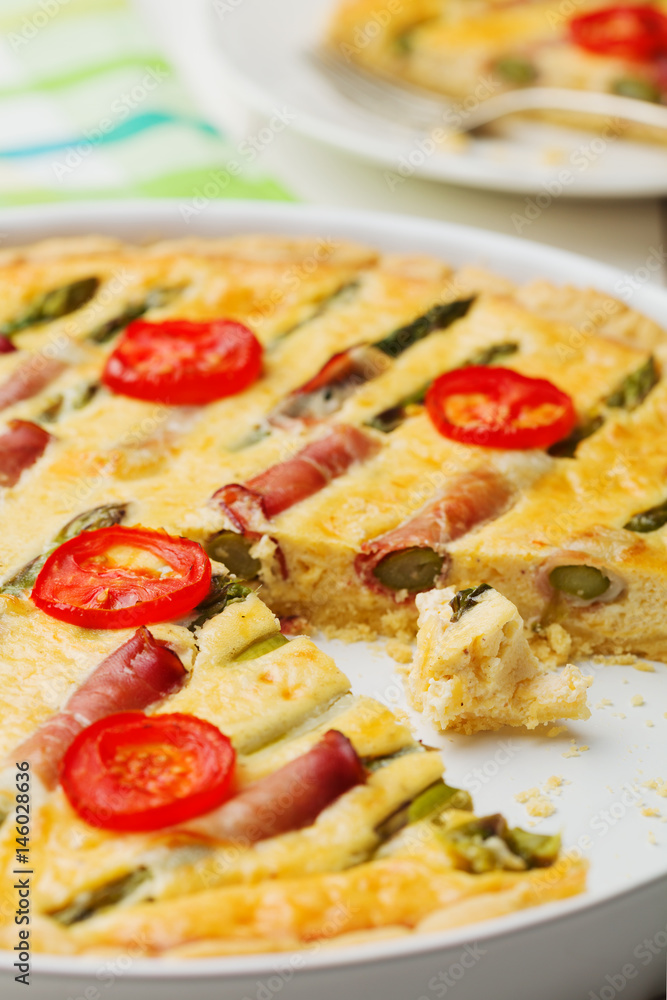 Tart with asparagus and tomatoes on white wooden background. Tart with asparagus and tomatoes on white wooden background.