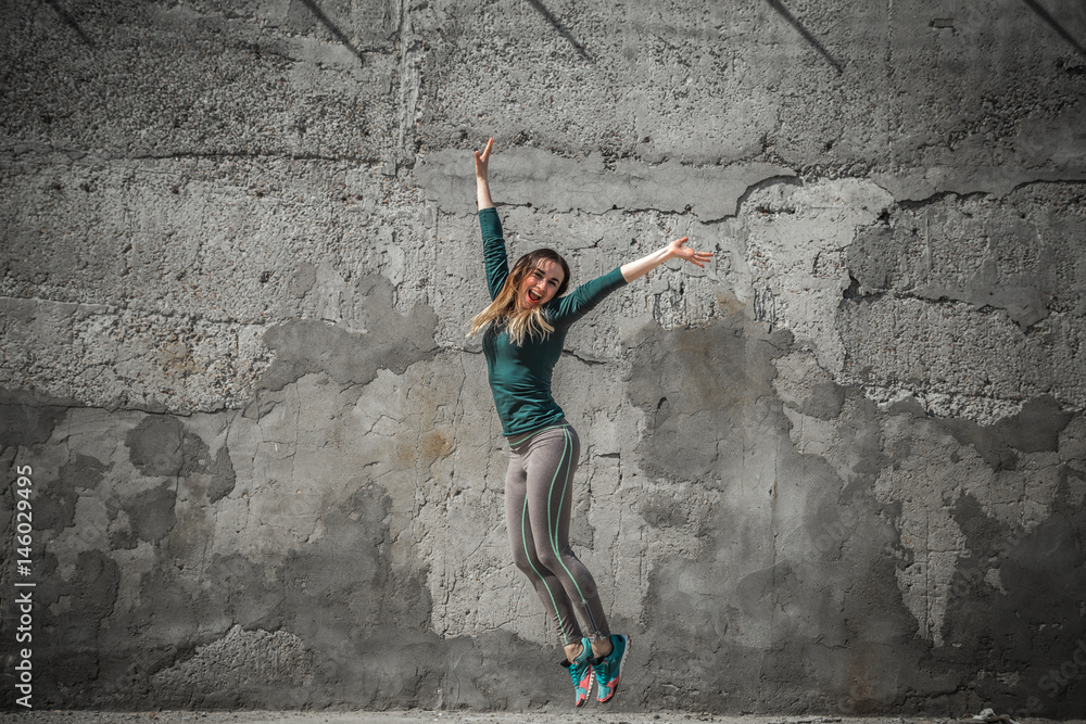 fitness girl in sport clothes on wall background Stock 写真 | Adobe Stock