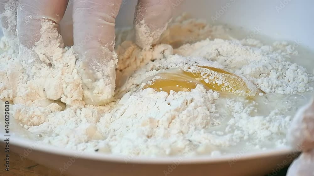 Mixing flour and yeast in the bowl by hand Mixing flour and yeast in the bowl by hand