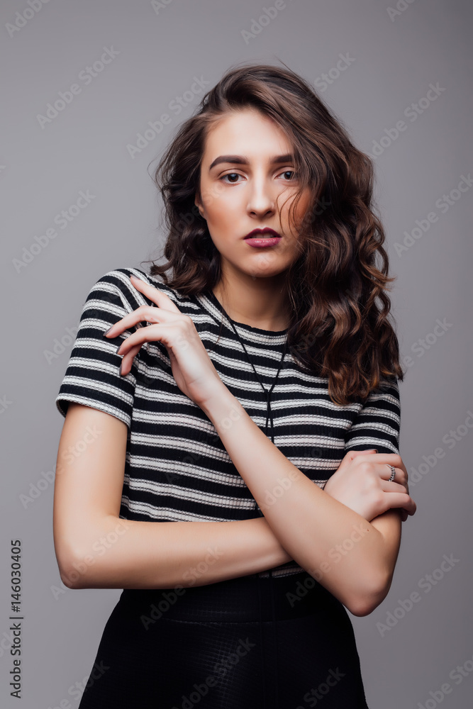 Fashion portrait pretty sweet young woman over grey background Fashion portrait pretty sweet young woman over grey background