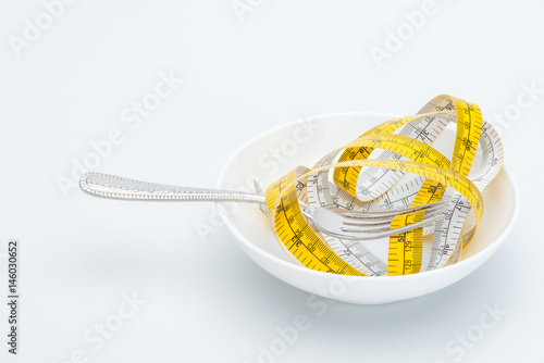 measuring tape on fork isolated on white, healthy living concept
