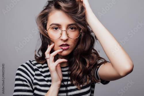 Fashion portrait pretty sweet young woman face over grey background