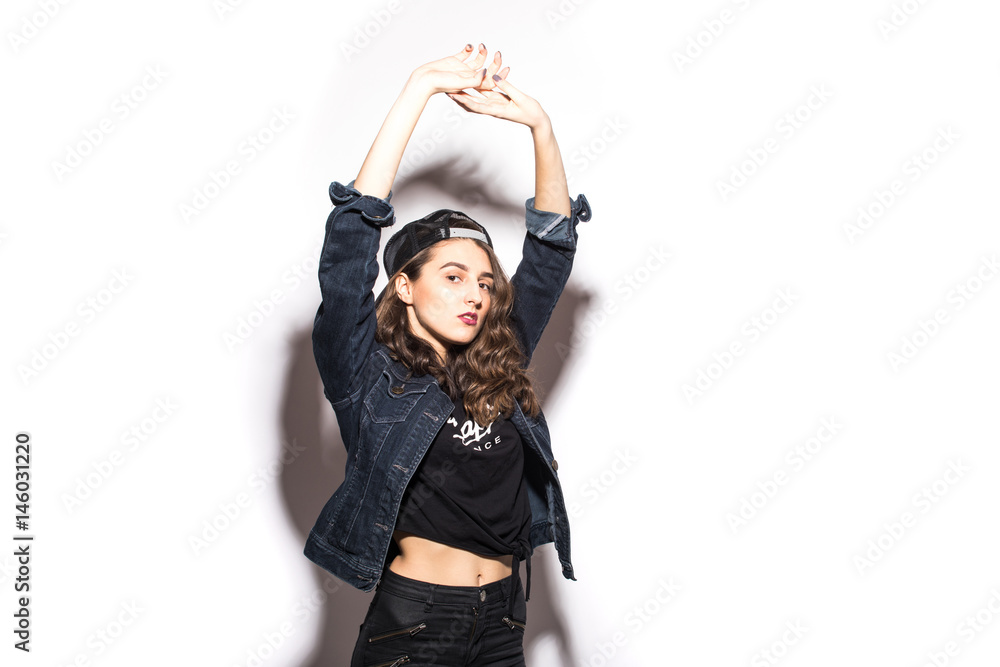 Hipster woman wear in stylish clothes and cap with raised hands on white background Hipster woman wear in stylish clothes and cap with raised hands on white background