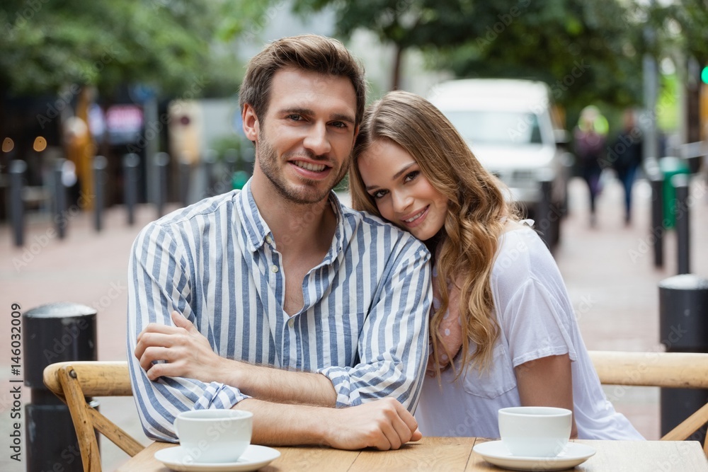 Portrait of smiling couple sitting at sidewalk cafe Portrait of smiling couple sitting at sidewalk cafe