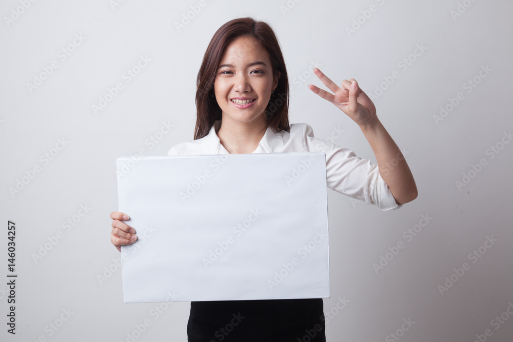 Young Asian business woman show victory sign with blank sign. Young Asian business woman show victory sign with blank sign.