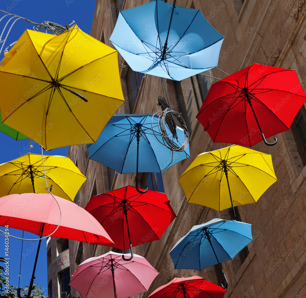 Multicolored umbrellas on street.