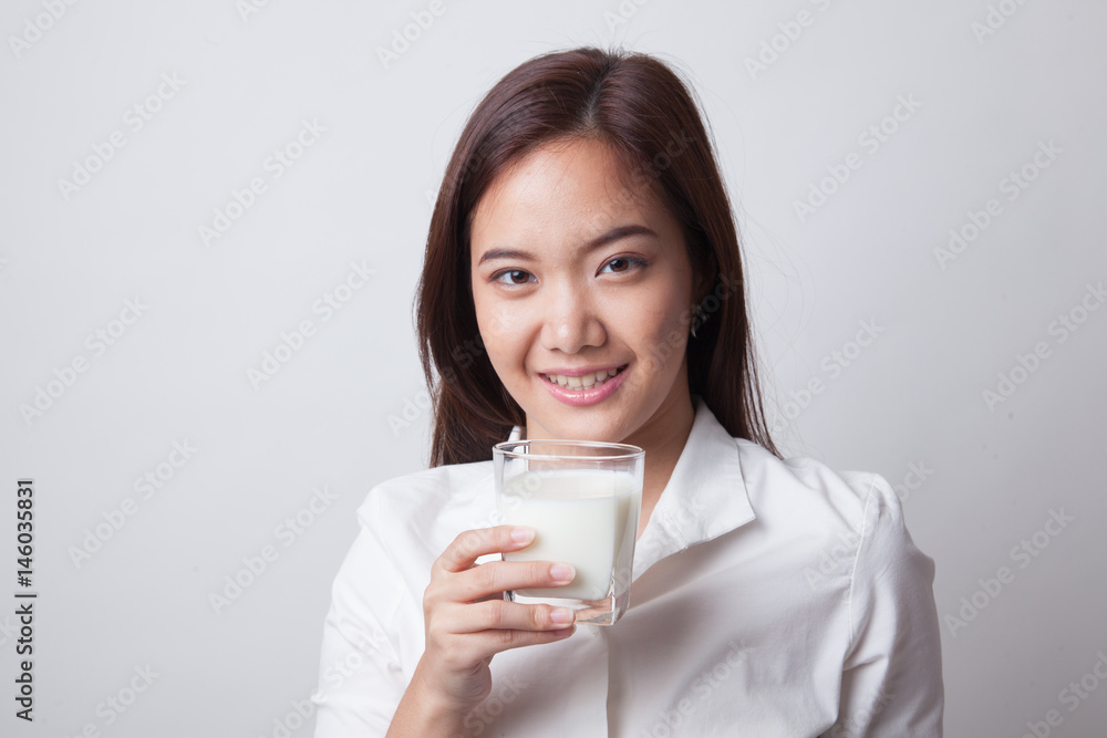 Healthy Asian woman drinking a glass of milk. Healthy Asian woman drinking a glass of milk.