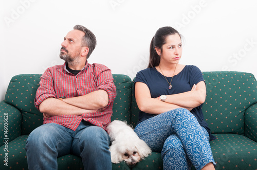 Couple having a quarrel while sitting on sofa