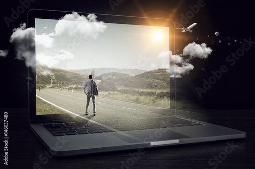 Man on huge laptop © Sergey Nivens